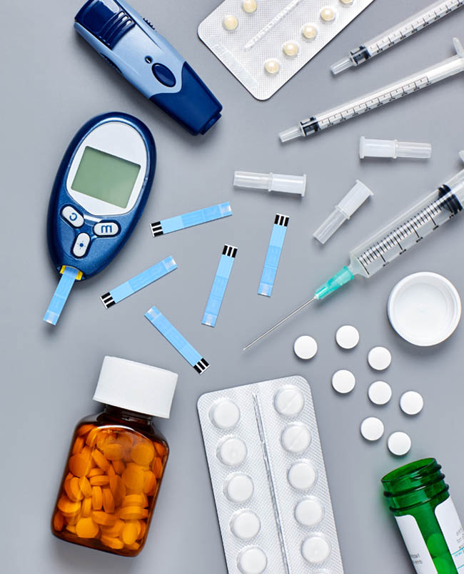 Picture of prescription drugs, a blood sugar tester and test strips