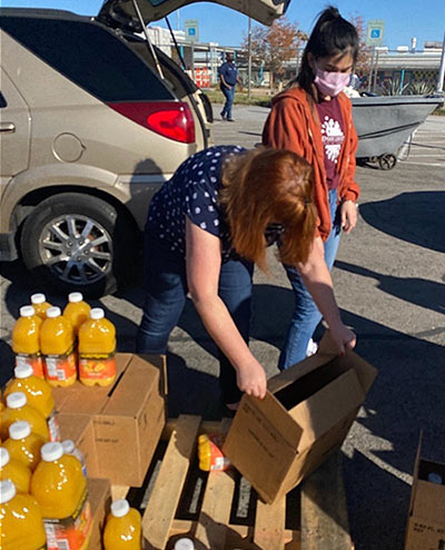 Picture of 2 women unpacking food for donation