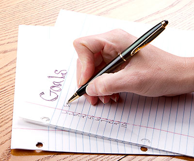 Picture of someone writing a list of goals